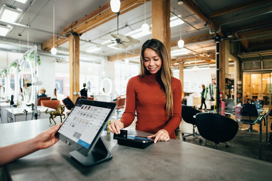 A shop owner taking a payment at her counter